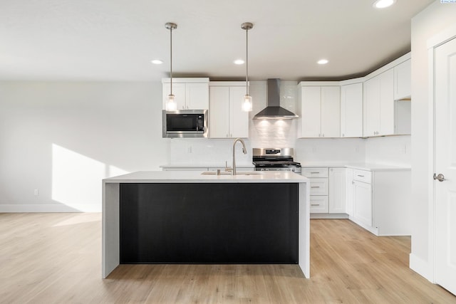 6531 W 30th Pl, Kennewick, WA 99338 - kitchen featuring wall chimney range hood, stainless steel appliances, light countertops, light wood-type flooring, and recessed lighting