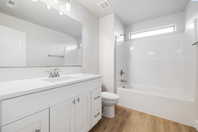 6531 W 30th Pl, Kennewick, WA 99338 - bathroom featuring wood finished floors, vanity, and washtub / shower combination