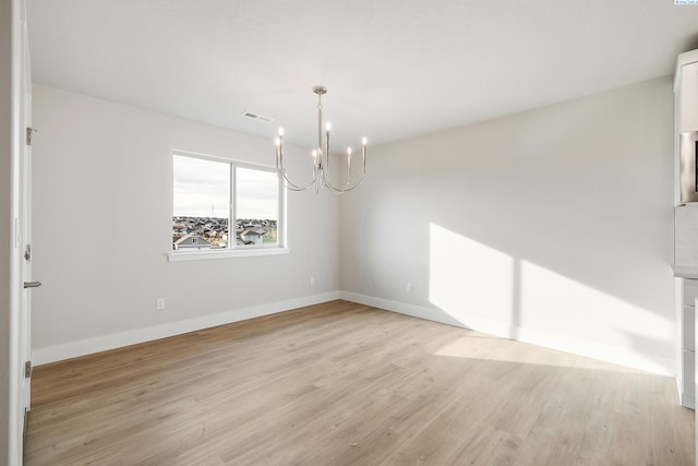 6531 W 30th Pl, Kennewick, WA 99338 - unfurnished room with a chandelier and light wood finished floors