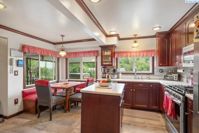 47001 Sr 27, Tekoa, WA 99033 - kitchen featuring stainless steel gas range oven, light countertops, a sink, crown molding, and light wood finished floors