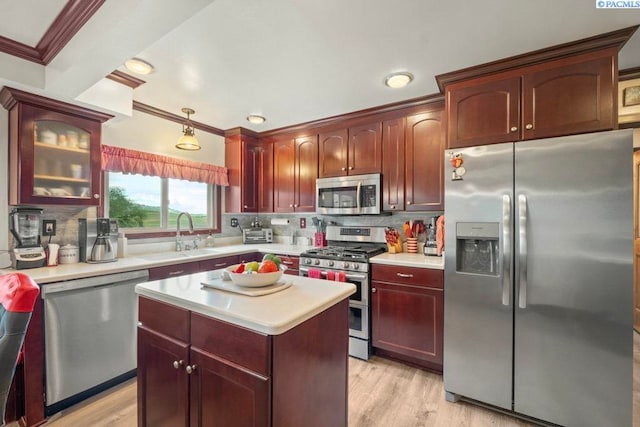 47001 Sr 27, Tekoa, WA 99033 - kitchen featuring stainless steel appliances, ornamental molding, light countertops, backsplash, and reddish brown cabinets