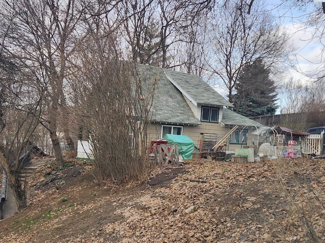 exterior space with a shingled roof