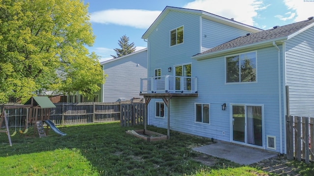 1625 NW Valhalla Dr, Pullman, WA 99163 - back of house with a playground, a balcony, and roof with shingles
