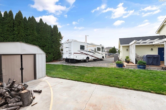 view of yard with a patio, a storage unit, and an outdoor structure