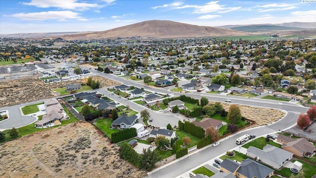 drone / aerial view featuring a residential view and a mountain view