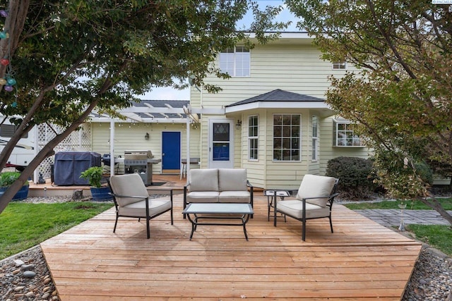 wooden terrace featuring outdoor lounge area and area for grilling