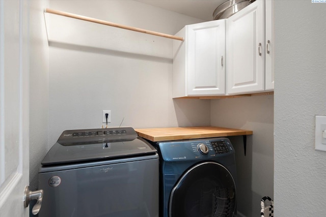 washroom with cabinet space and washing machine and dryer