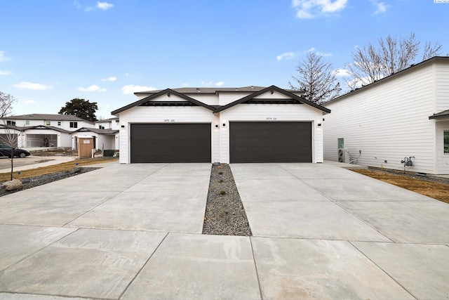 modern farmhouse style home featuring a garage and concrete driveway