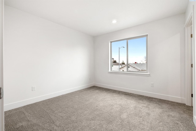 spare room featuring baseboards, recessed lighting, and carpet