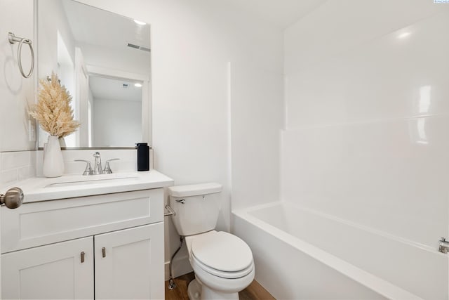 bathroom featuring toilet, visible vents, wood finished floors, and vanity