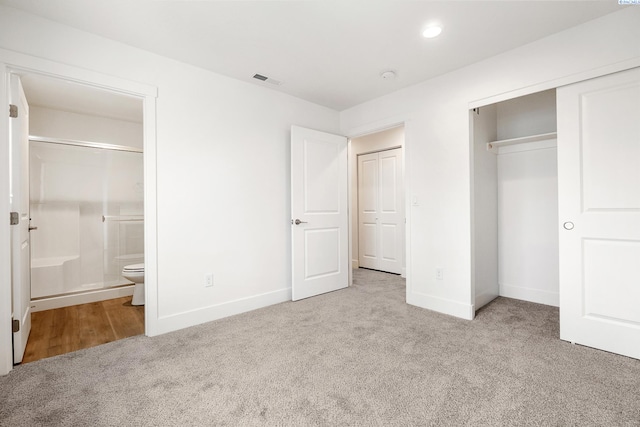 unfurnished bedroom with carpet flooring, recessed lighting, baseboards, ensuite bathroom, and a closet
