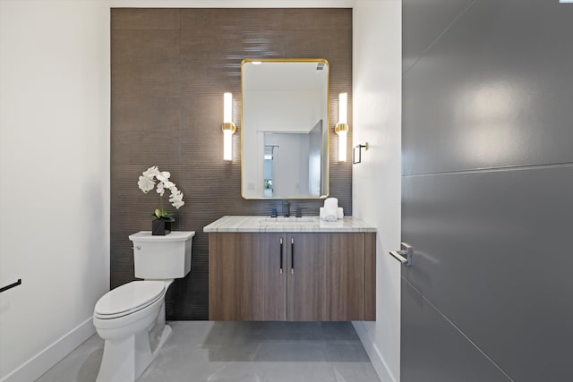 bathroom with tile patterned floors, vanity, and toilet