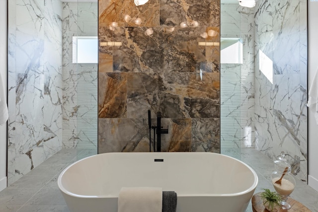 bathroom featuring a tub to relax in and tile walls