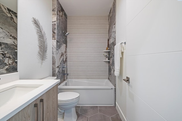 full bathroom with tiled shower / bath, vanity, toilet, and tile patterned flooring