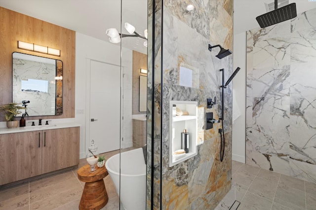 bathroom featuring vanity, independent shower and bath, and tile walls