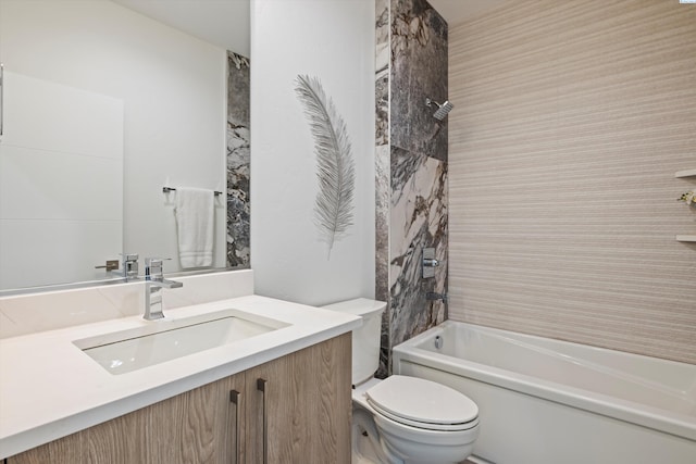 full bathroom with vanity, tiled shower / bath, and toilet