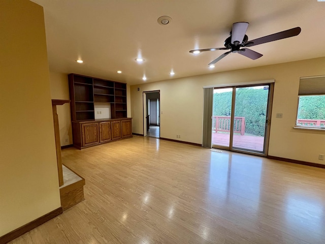 unfurnished living room featuring ceiling fan and light wood-type flooring