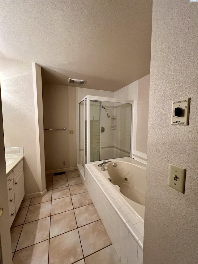 bathroom with independent shower and bath, vanity, tile patterned floors, and a textured ceiling