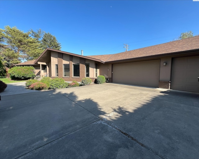 2557 Lancer Pl, Walla Walla, WA 99362 - view of front of house featuring brick siding, an attached garage, and concrete driveway