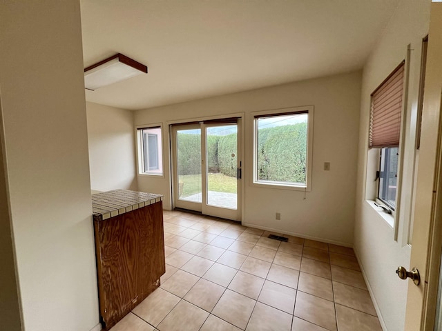 entryway featuring light tile patterned floors