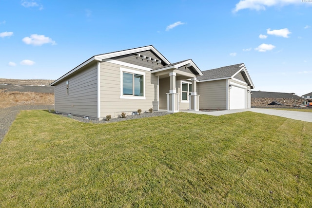 view of front of home featuring an attached garage, driveway, and a front yard