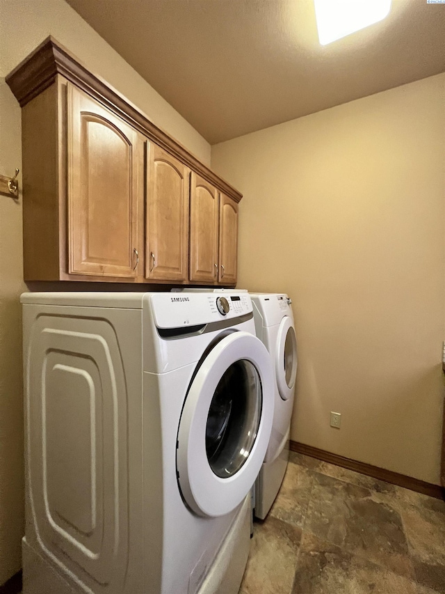 laundry area featuring cabinets and separate washer and dryer