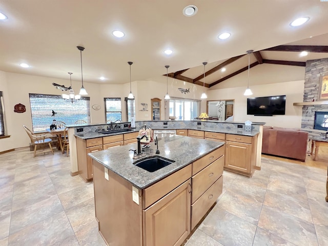 kitchen featuring hanging light fixtures, a large island, sink, and vaulted ceiling with beams