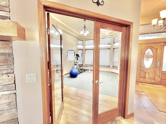 interior space with french doors and a notable chandelier