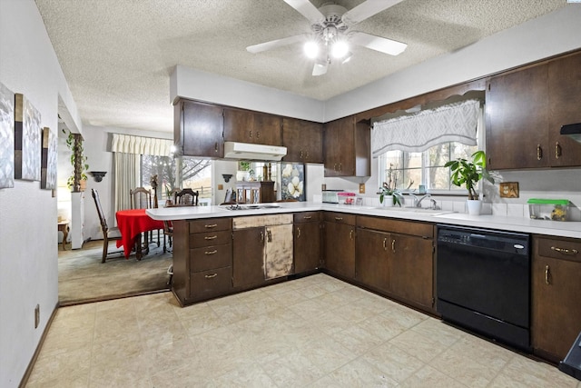 697 Conrad Rd, Touchet, WA 99360 - kitchen with dishwasher, light countertops, under cabinet range hood, a peninsula, and a sink