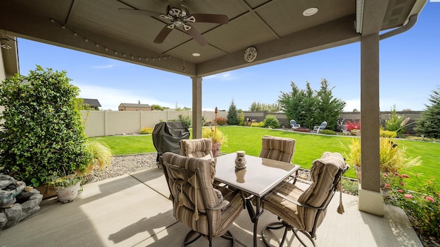 8902 Sophie Rae Ct, Pasco, WA 99301 - fenced backyard with a ceiling fan, a patio, outdoor dining space, and a grill