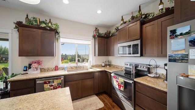 8902 Sophie Rae Ct, Pasco, WA 99301 - kitchen featuring appliances with stainless steel finishes, light countertops, dark wood-style flooring, recessed lighting, and dark brown cabinets