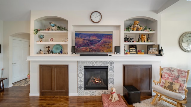 8902 Sophie Rae Ct, Pasco, WA 99301 - living room with a tiled fireplace, wood finished floors, and built in features