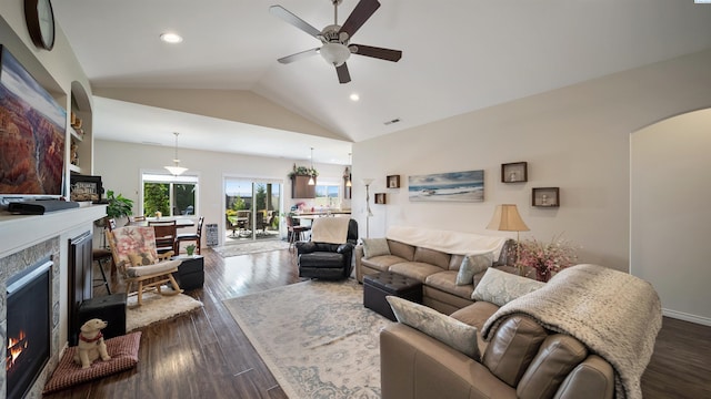 8902 Sophie Rae Ct, Pasco, WA 99301 - living room with a warm lit fireplace, arched walkways, ceiling fan, lofted ceiling, and recessed lighting