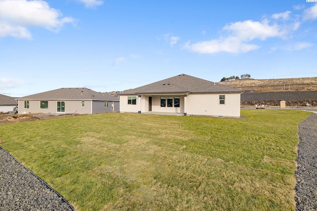 back of property featuring a yard and a patio