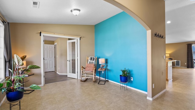 5706 Wrigley Dr, Pasco, WA 99301 - sitting room with arched walkways, french doors, baseboards, and vaulted ceiling