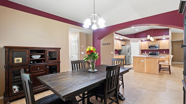 5706 Wrigley Dr, Pasco, WA 99301 - dining area featuring arched walkways, lofted ceiling, a chandelier, and baseboards