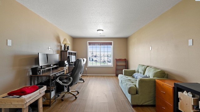 5706 Wrigley Dr, Pasco, WA 99301 - office area with light wood-style floors, a textured ceiling, and baseboards