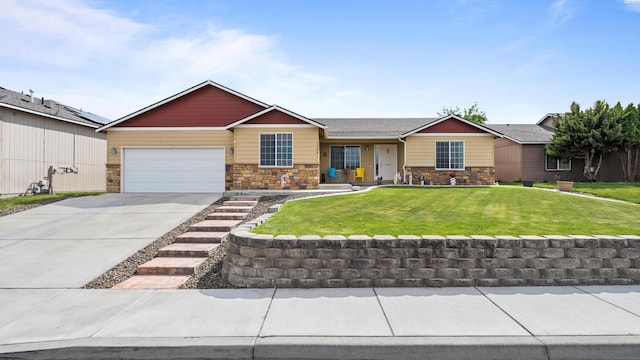 5706 Wrigley Dr, Pasco, WA 99301 - view of front of home featuring stone siding, a garage, driveway, and a front yard