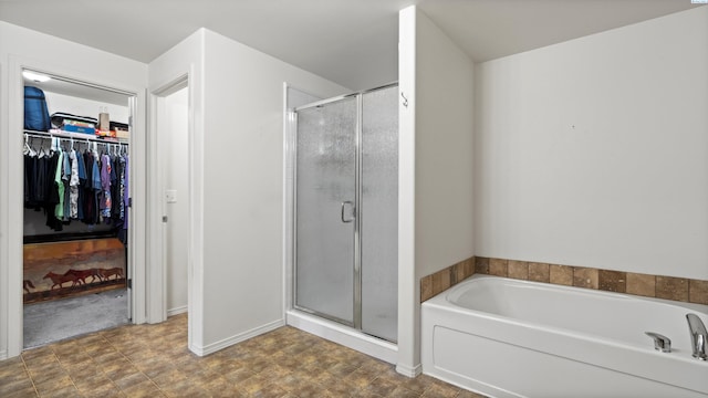 5706 Wrigley Dr, Pasco, WA 99301 - bathroom featuring a stall shower, a garden tub, a walk in closet, and baseboards