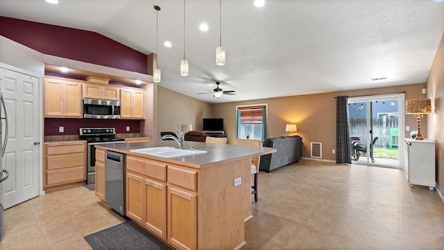 5706 Wrigley Dr, Pasco, WA 99301 - kitchen with appliances with stainless steel finishes, light brown cabinetry, open floor plan, a sink, and a ceiling fan