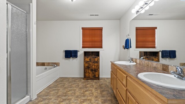 5706 Wrigley Dr, Pasco, WA 99301 - full bathroom featuring a shower stall, a garden tub, double vanity, and baseboards