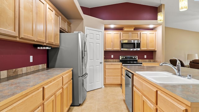 5706 Wrigley Dr, Pasco, WA 99301 - kitchen featuring stainless steel appliances, light brown cabinetry, a sink, vaulted ceiling, and hanging light fixtures