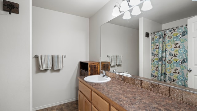 5706 Wrigley Dr, Pasco, WA 99301 - bathroom with a chandelier, baseboards, vanity, and curtained shower