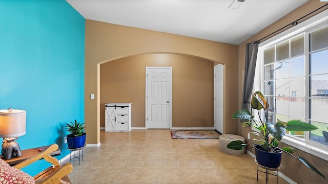 5706 Wrigley Dr, Pasco, WA 99301 - living area with arched walkways, plenty of natural light, baseboards, and lofted ceiling