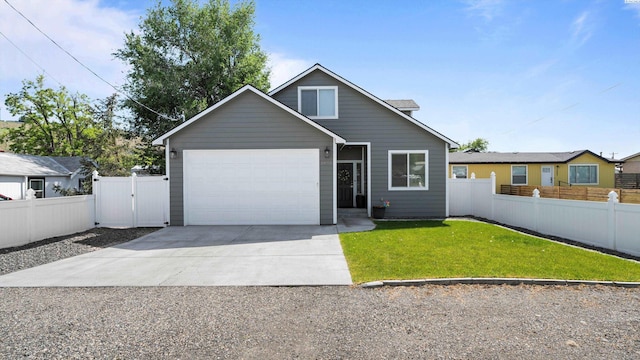 5971 Deer St, West Richland, WA 99353 - view of front of house with driveway, a garage, and a gate