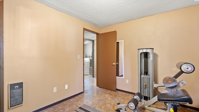 1707 S Fruitland St, Kennewick, WA 99337 - exercise area featuring washer / dryer, a textured ceiling, tile patterned floors, and heating unit