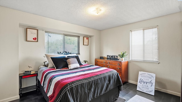 1707 S Fruitland St, Kennewick, WA 99337 - bedroom featuring a textured ceiling and dark wood-style floors