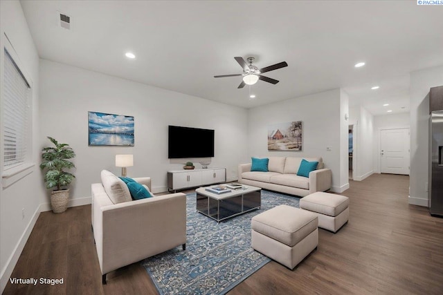 living room with dark hardwood / wood-style floors and ceiling fan