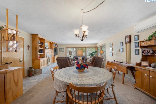 407 Steptoe St, Colton, WA 99113 - dining area featuring an AC wall unit, a textured ceiling, light colored carpet, a chandelier, and a fireplace