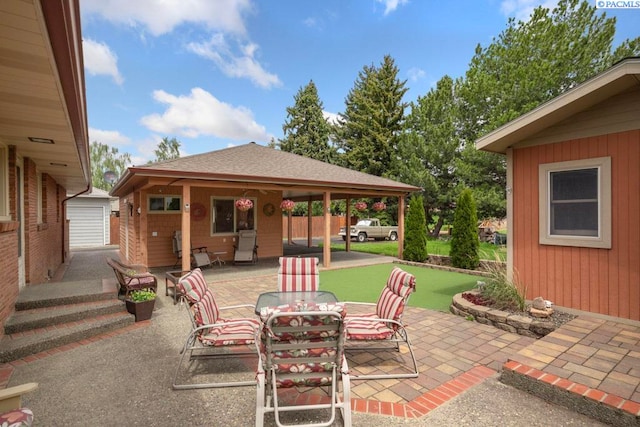 407 Steptoe St, Colton, WA 99113 - view of patio with a putting green, an outbuilding, and outdoor dining area